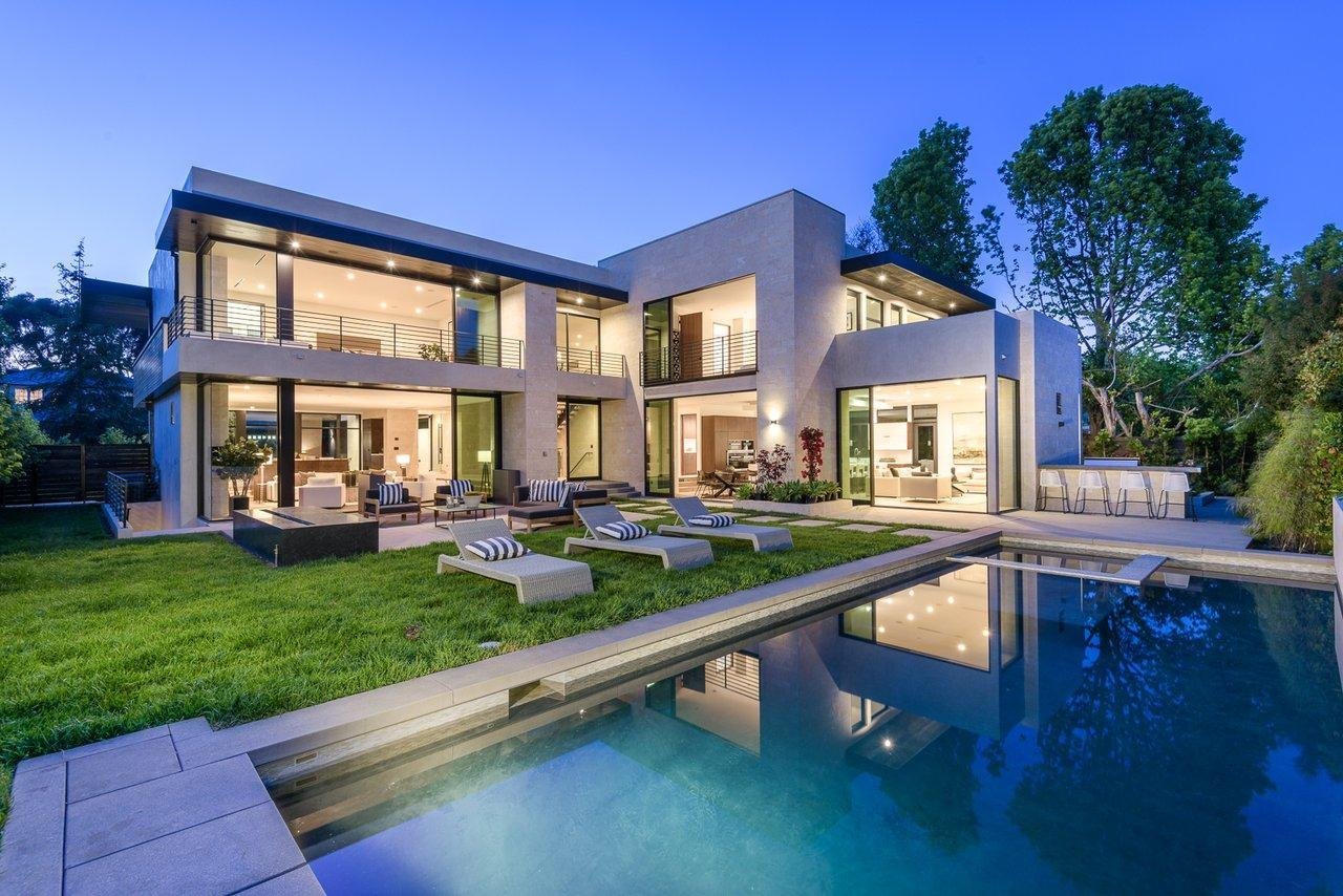 Modern luxury residential home at dusk with pool, reviewed for structural safety and permit readiness